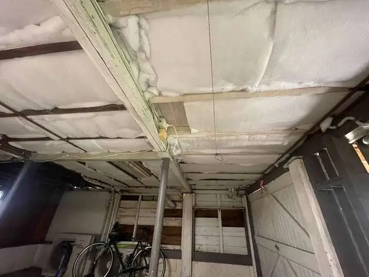 White polyester insulation fitted beneath a timber floor.